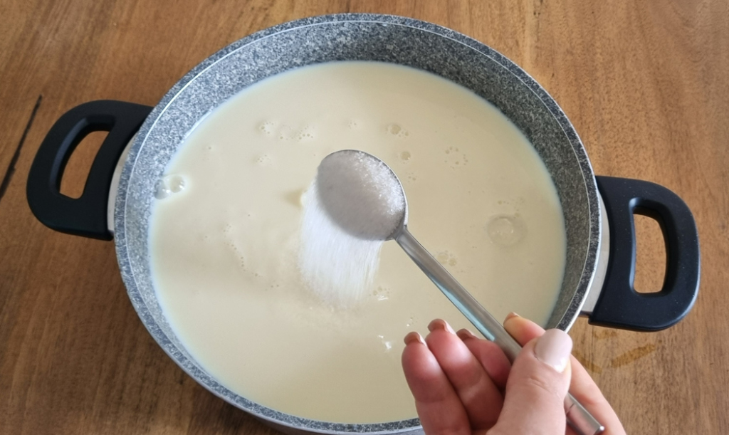 A photo showing the addition of sugar to colostrum