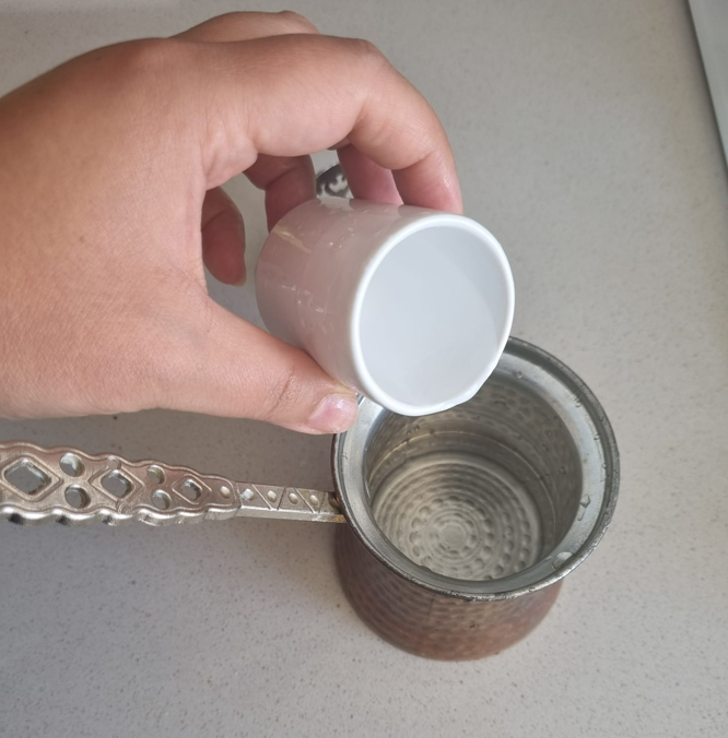 A photo of adding water to the coffee pot