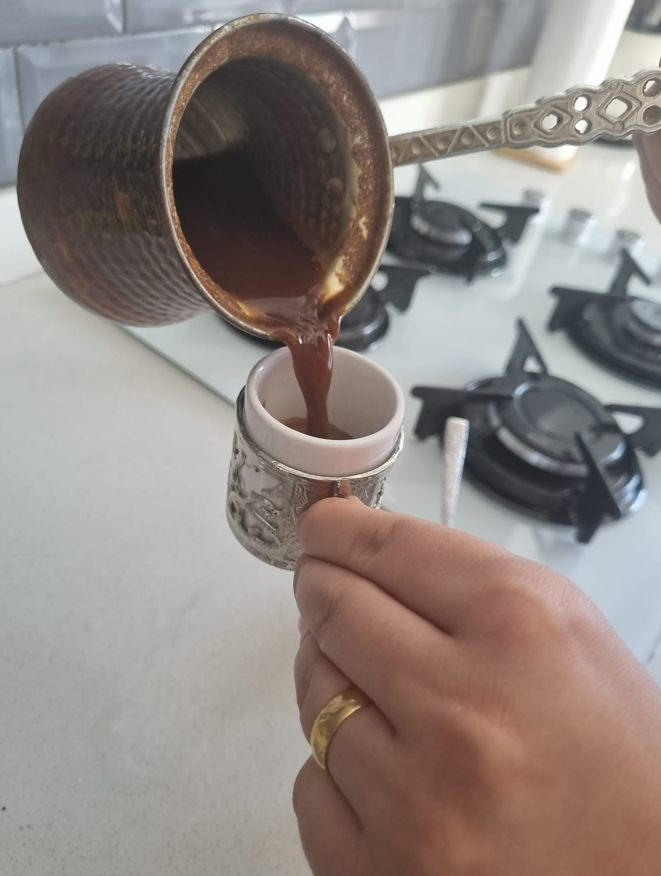 A photo showing Turkish coffee being poured into cups